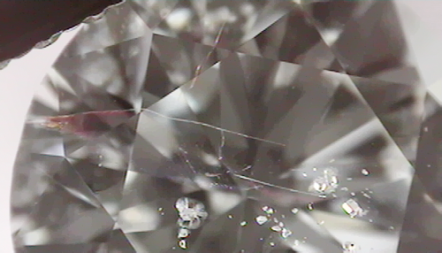 Fracture filled diamond. The filled fracture can be identified by its colorful flash effect.